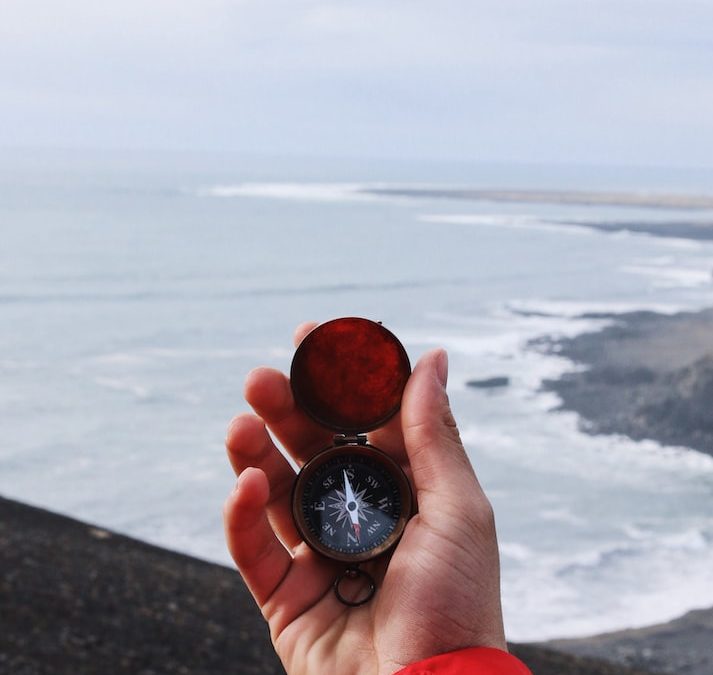 person holding compass